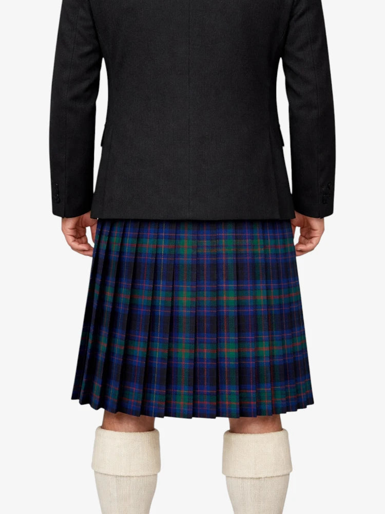 Person wearing a black jacket and plaid kilt on a white background