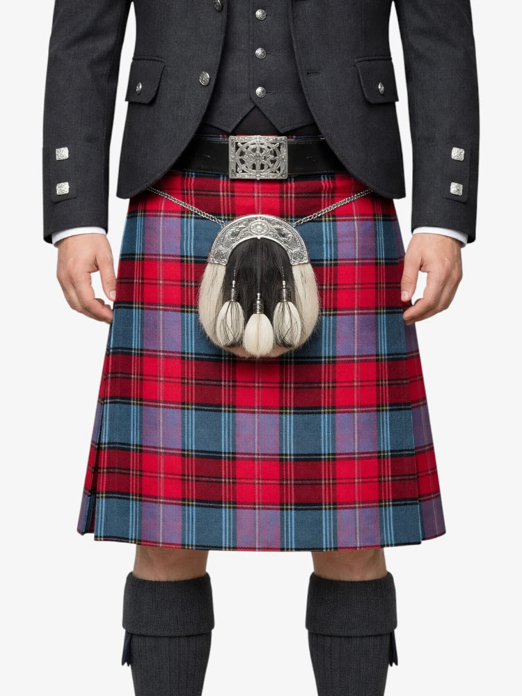 Person wearing a red and blue plaid kilt with a dark jacket and knee-high socks on a white background