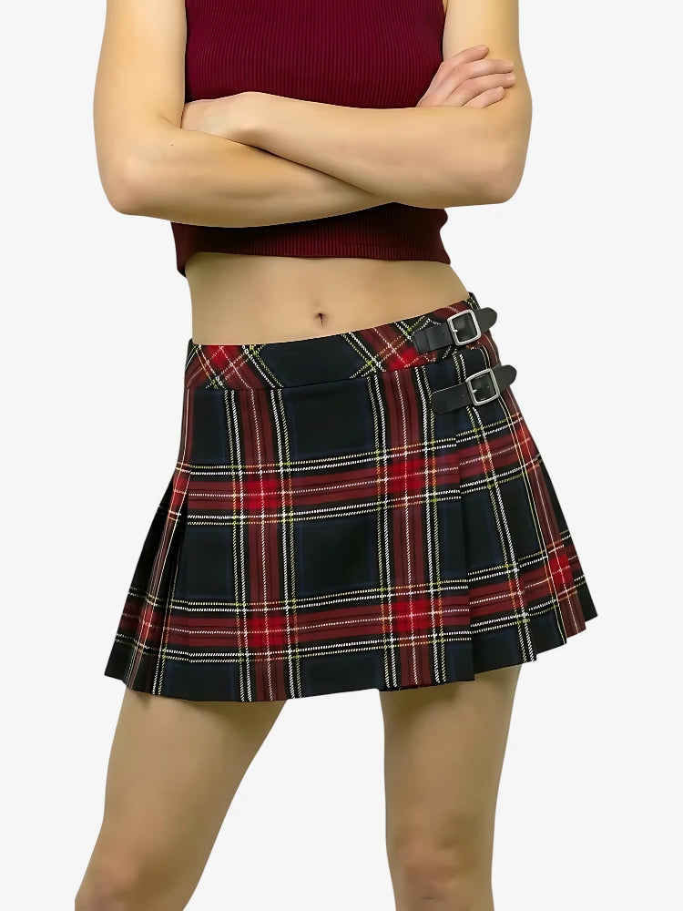 Person wearing a plaid skirt with a plain background