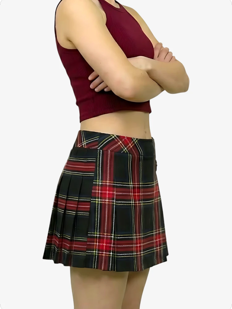 Person wearing a maroon tank top and plaid skirt on a white background
