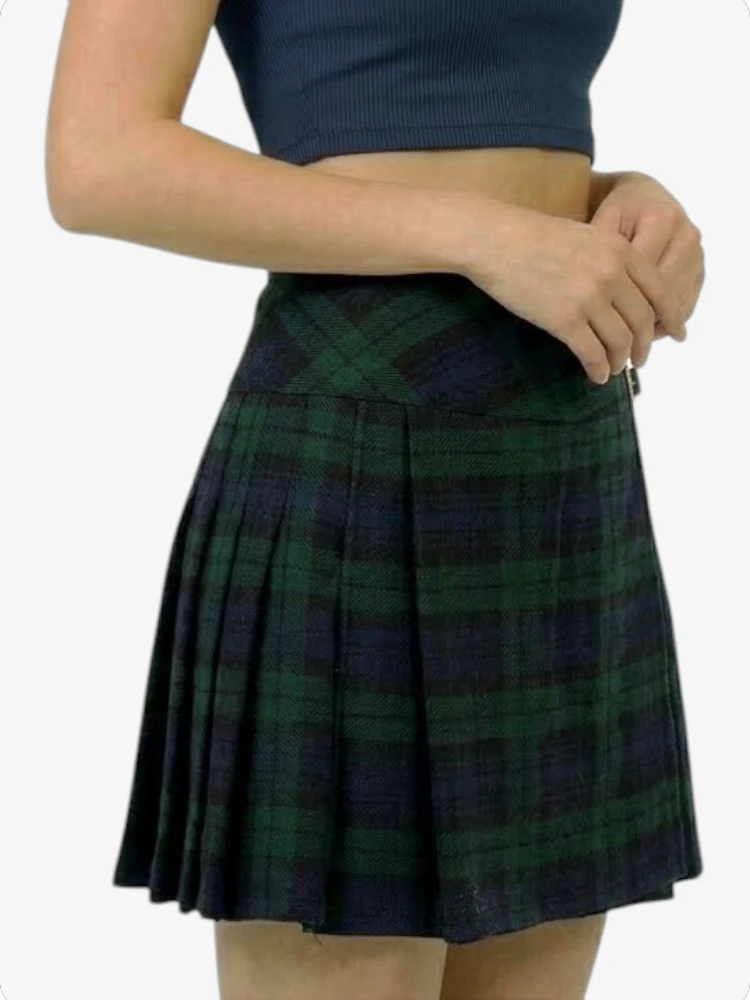 Person wearing a green plaid skirt on a white background