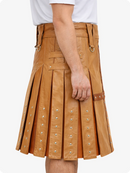 Camel leather kilt with metal studs on a white background