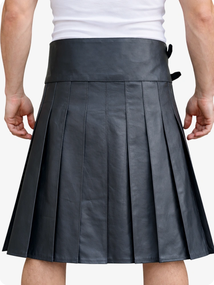 Person wearing a pleated gray skirt on a white background