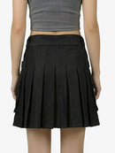 Black pleated skirt worn by a person on a white background