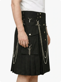 Black kilt with chain details worn by a person on a white background