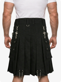 Black kilt with silver chain details worn by a person on a white background