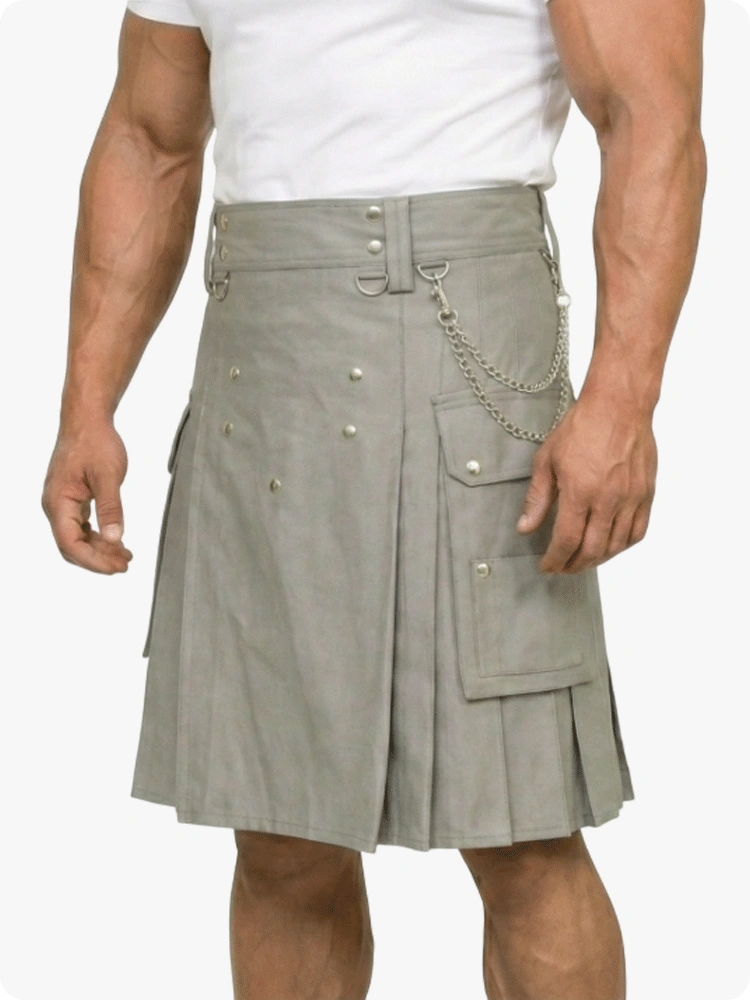 Man wearing a gray kilt with chains on a white background