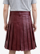 Person wearing a Burgundy pleated skirt and gray t-shirt on a white background