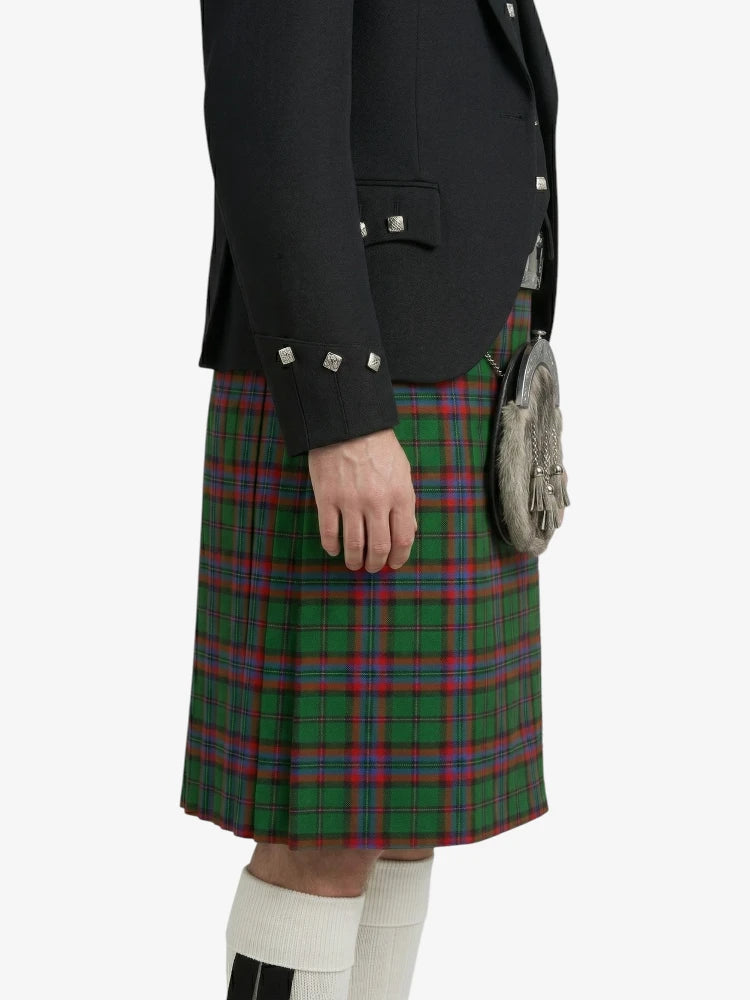 Person wearing a black jacket and green plaid kilt on a white background