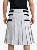 White pleated skirt with black straps worn by a person on a white background